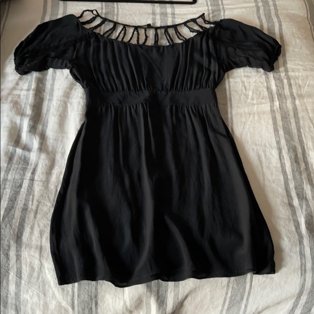 Black cocktail dress with shoulder detail